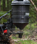 ATV Spreader With Manual Feed Gate For Seed Or Fertilizer, 100 Pound Hopper, Heavy Duty 12 Volt Motor, operating in forest
