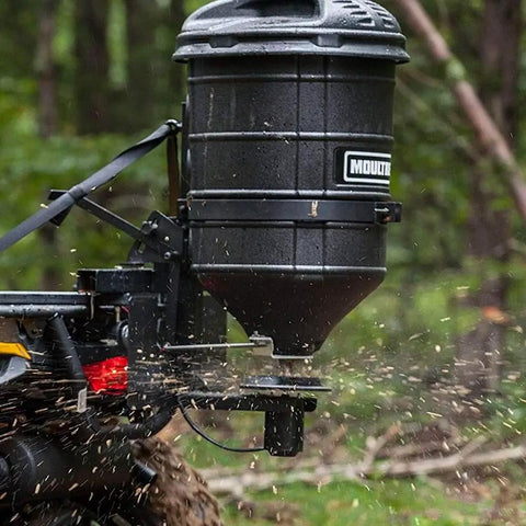 ATV Spreader With Manual Feed Gate For Seed Or Fertilizer, 100 Pound Hopper, Heavy Duty 12 Volt Motor, operating in forest