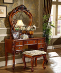Elegant vintage-style dressing table set with a carved mirror and cushioned stool, featuring ornate wood detailing, placed in a classic room.