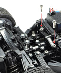Close-up of RC car steering system with TT02 3x18mm Low Friction Step Screws Two Piece Upgrade enhancing performance.