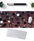 Ultra Large Anime Themed Gaming Mouse Pad With Pom Pom Stars Oversized Desk Pad For Computer Setup Smooth Non Slip Surface 31.5 By 11.8 Inches Stitched Edges Desk Decor For Women And Gamers featuring cute black soot sprites and colorful star designs, photographed on a desk with keyboard and plant nearby.