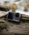 Rock Solid Waterproof Action Camera Bundle Shoots Clean 4K With Large Sensor on wet log in nature.