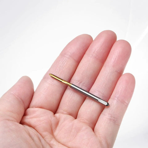 Four Pack M2x0.4mm Metric Thread Taps With Titanium Coated HSS Steel 44mm Straight Flute shown in hand for CNC applications