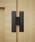 3.5 Inch Black Wrought Iron H Hinge With 1/4 Inch Offset For Kitchen Cabinets installed on light wood surface
