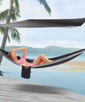 Woman relaxing in Heavy Duty Camping Hammock With Rain Fly Tarp And Mosquito Net 440 Lb Capacity Portable Tree Hammock by beach.