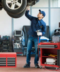 Mechanic working with Rolling Tool Chest With Five Drawers, Lockable Wheels, Sliding Drawers, Detachable Top, And Adjustable Shelf in garage