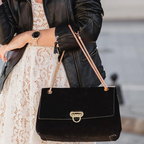 Handbag front view: black velvet with gold-tone turn-lock clasp and chain strap