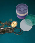 Round Watch Parts Tray With Stackable Layers And Portable Storage Case Built Tough With ABS Your Go To Gear Organizer For Small Screws Springs Clips Fix Kits Horology Supplies And Workshop Essentials tray shown with watch parts.