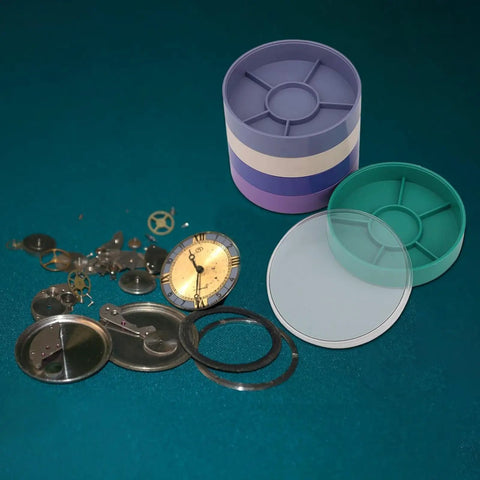 Round Watch Parts Tray With Stackable Layers And Portable Storage Case Built Tough With ABS Your Go To Gear Organizer For Small Screws Springs Clips Fix Kits Horology Supplies And Workshop Essentials tray shown with watch parts.