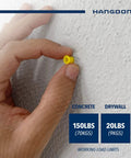 Hand holding yellow ribbed wall anchor pushed into drywall showing Ribbed Wall Anchor Kit For Drywall And Concrete 100 Pack Yellow Nylon Anchors With Screws Included Seven Eighths Inch Length For Mounting Shelves Mirrors Cabinets And Lamps Pan Head Phillips Screws