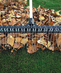 Heavy-Duty 55-Inch Fiberglass Rake With A 21-Inch Steel Tined Head For De-Thatching And Landscaping on lawn with leaves