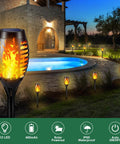8 Pack 12 LED Solar Torch Lights With Flickering Flame illuminating a garden pathway near a pool at night, outdoor decor.