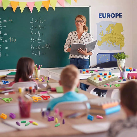 Back To School Essentials Kit 360 Pcs For Kids Featuring Pencil Top Erasers, Student Scissors, And Miniature Pencil Sharpeners With Covers on desks in classroom