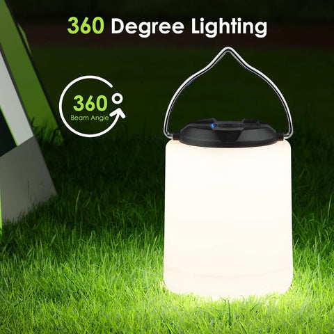 Powerful 1000LM LED Camping Lantern with Rechargeable Battery emitting 360-degree warm light on grass at night