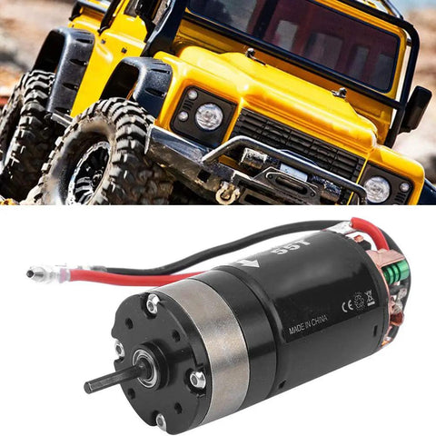 Beefy Metal Gearbox Upgrade With 540 Brushed 55T Motor in front of RC Crawler, compatible with SCX10 and HSP 1/10 cars