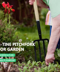 Person using Heavy Duty 45 Inch Garden Fork 4 Tine Pitchfork With Forged Steel Y Grip And Solid Wood Handle Spading Digging Fork in garden bed.