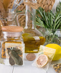Clear 3 By 3 Inch Reclosable Zip Bags Pack Of 1200 2 Mil Thick Food Safe Poly Bags with herbs and lemon on a kitchen counter.