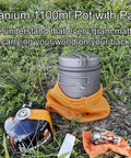 Titanium 1100ml Pot And Pan Set For Backpacking Ultralight Outdoor Cooking Gear with mesh bag next to camp stove on grass