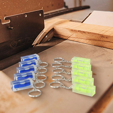Green and Blue for acrylic Square for spirit Level Bubble Inclinometer keychains on a workbench, compact and precise.