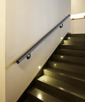 7FT Modern Aluminum Wall Mount Handrail Matte Black on indoor staircase with lights, providing support and safety.