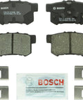 Bosch BC1086 rear ceramic brake pad set with four pads, mounting hardware, and lubricant sachet.