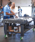 Top Shelf 5 Inch Polyurethane On Cast Iron Caster Wheel With Precision Needle Roller Bearing Fast Half Inch Bore handles heavy industrial equipment in use.