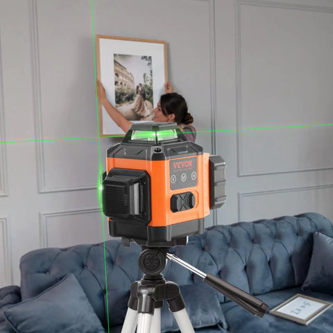 100ft Green Self Leveling Laser Level With 3 X 360 Degree Cross Lines on tripod, used for picture alignment in a room.