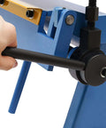 Close-up of hand operating 24 Inch Pan And Box Brake Sheet Metal Hand Tool With Removable Fingers For Precise Bends in blue