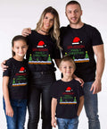 Family wearing matching Christmas T-shirts with festive design.