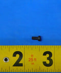 Hella Durable Indexable Insert Retaining Screw For CNC Milling And Turning Tools positioned next to a measuring tape on a blue background.