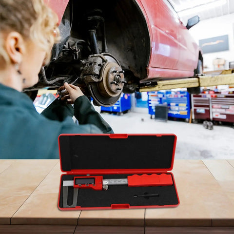 Digital Brake Disc Caliper 0-150mm Stainless Steel LCD Electronic Vernier in red case next to a car being repaired.