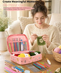 Woman using No-Brainer Crochet Starter Kit For Beginners With Ergonomic Hooks And 59-Piece Yarn Bundle All-In-One Set, smiling.