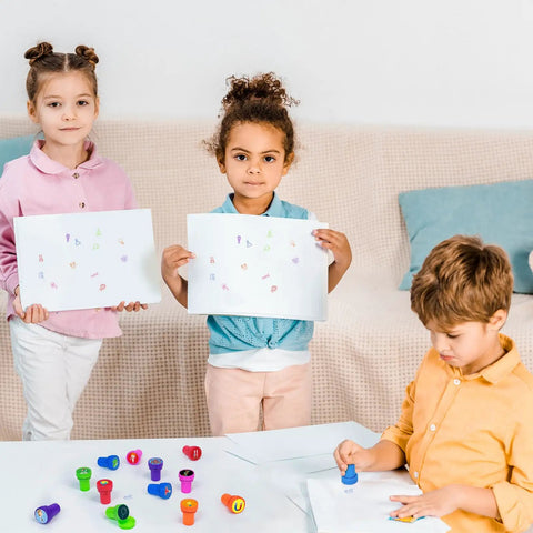 Children using Science Party Stampers 24 Pack With 12 Designs for DIY crafts and fun activities around a table.