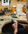 Person using Pro Grade Metal File Set With 12 Needle Files And Storage Bag Including Large Flat Half Round Triangle And Round Files Plus Steel Brush for woodworking at a workbench.