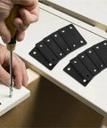 Tough As Nails Stainless Steel Mending Plates And Square Connecting Brackets For Knocking Out Fast Furniture Repairs And Rock Solid Shelf Reinforcement With Dead Tight Screws For Weekend Warriors being installed on a shelf with a screwdriver.