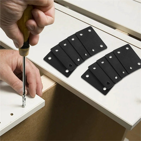 Tough As Nails Stainless Steel Mending Plates And Square Connecting Brackets For Knocking Out Fast Furniture Repairs And Rock Solid Shelf Reinforcement With Dead Tight Screws For Weekend Warriors being installed on a shelf with a screwdriver.