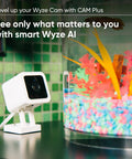 Indoor And Outdoor Plug In Smart Security Camera With AI Motion Alerts near a vibrant fish tank setup indoors.