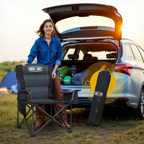 Person with Oversized Folding Camping Chair With 500 Lbs Support, Padded Cushion And Built-In Cooler Pockets