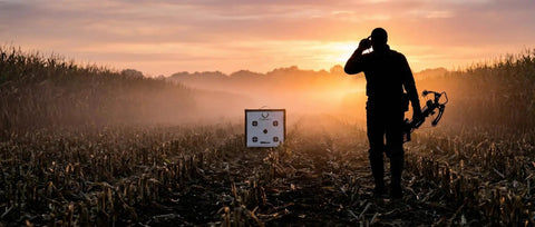 Archer with compound bow near Backyard Crossbow Target With 650 FPS Stopping Power at sunset in a field.
