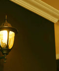 Original 9W LED Bug Light For Porch Patio And Entry Way With Gentle Glow That Keeps Bugs Away illuminating a wall sconce, indoor view.