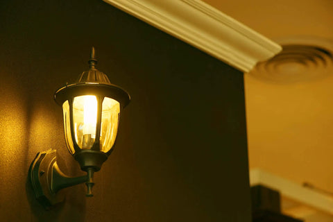 Original 9W LED Bug Light For Porch Patio And Entry Way With Gentle Glow That Keeps Bugs Away illuminating a wall sconce, indoor view.