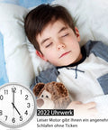 Child sleeping peacefully next to clock with text '2022 Uhrwerk', promoting quiet and smooth clock movement.