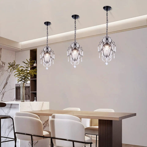 Crystal Mini Black Chandelier With Adjustable 41.3 Inch Chain illuminating modern dining area with white chairs.