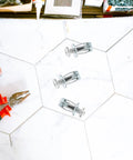 25 Piece Thread Nut Insert Kit For Metal With Easy Installation And High Reliability Galvanized Carbon Steel Petal Rivet Nuts For Hollow Wall Fastening And Secure Mounting In DIY Projects. three metal rivet nuts on tile with pliers