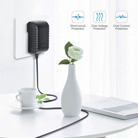 AC Charger Adapter For Extech Flir I3 I5 I7 Thermal Imaging Infrared Cameras, plugged into wall outlet on table with vase and cup