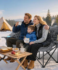 Family enjoying snowy scenery on Two Person Padded Camping Chair For Outdoor Lounging, Heavy Duty Oversized Camping Loveseat, Gray