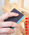 Top Shelf Workhorse Sanding Sponge Set Six Piece Kit With 60 To 320 Grit Double Sided Blocks Wet Dry Use On Wood Metal Auto Body Smooth Out Scratches And Blemishes Daily, hand holding sponge with grit labels.