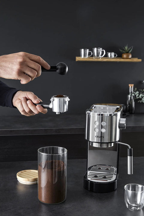 Semi Automatic Espresso Coffee Maker With Built In Steam Wand And High Pressure Pump For Rich Creamy Shots, user adding coffee grounds.