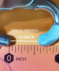 Close-up of a 316 stainless steel swivel trigger snap hook with a large opening about 0.5 inches beside a ruler