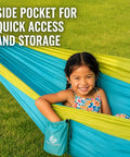 Child enjoying Ultra Lightweight Camping Hammock With 500 Lb Capacity and tree straps, featuring side pocket for storage.